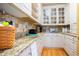 Spacious pantry features granite counters, tile backsplash, custom cabinets with glass doors and wood flooring at 9 Gasparilla Circle, Murrells Inlet, SC 29576