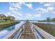 Long wooden pier leading to covered gazebo with views of marsh and waterway at 9 Gasparilla Circle, Murrells Inlet, SC 29576