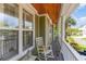 Relaxing porch with rocking chair, view to the yard, columns and stained wood ceiling at 9 Gasparilla Circle, Murrells Inlet, SC 29576