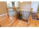 View of staircase with wood railing and hardwood floors at 9 Gasparilla Circle, Murrells Inlet, SC 29576