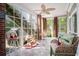 Relaxing sunroom with brick accents, tiled floors, ceiling fan and backyard view at 9 Gasparilla Circle, Murrells Inlet, SC 29576