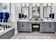 Elegant bathroom featuring dual sinks, ample vanity storage, and a luxurious soaking tub at 9407 Venezia Circle, Myrtle Beach, SC 29579