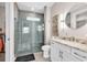 Stylish bathroom showcasing a glass-enclosed shower and modern vanity with a round mirror at 9407 Venezia Circle, Myrtle Beach, SC 29579