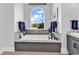 Bright bathroom with a large window above the tub offering nice views of outside scenery at 9407 Venezia Circle, Myrtle Beach, SC 29579