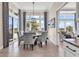 Bright dining area featuring a modern chandelier, large windows, and backyard access at 9407 Venezia Circle, Myrtle Beach, SC 29579