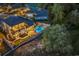 Aerial view showcases the well-lit exterior, beautiful pool, and landscaping of this luxurious property at 9407 Venezia Circle, Myrtle Beach, SC 29579