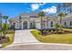 Stunning home featuring a tiled roof, well manicured landscaping, and paver driveway at 9407 Venezia Circle, Myrtle Beach, SC 29579
