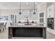 Modern kitchen with a large island, white cabinetry, and stainless steel appliances at 9407 Venezia Circle, Myrtle Beach, SC 29579