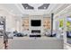 Living room with a large sofa, modern fireplace, built-in shelving, and access to the patio at 9407 Venezia Circle, Myrtle Beach, SC 29579