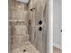 Modern walk-in shower with beautiful marble-look tile and a built-in niche for toiletries at 9407 Venezia Circle, Myrtle Beach, SC 29579
