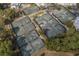 Aerial view featuring multiple well-maintained tennis courts surrounded by lush greenery at 9407 Venezia Circle, Myrtle Beach, SC 29579