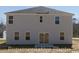 Two-story home with back patio and neutral siding at 978 Cherrystone Loop, Conway, SC 29526