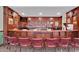 Rich wood paneled bar with seating, perfect for entertaining guests and displaying beverages at 978 Cherrystone Loop, Conway, SC 29526