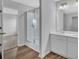 Modern bathroom with double vanity, framed mirror, a glass-enclosed shower and wood-look floors at 978 Cherrystone Loop, Conway, SC 29526