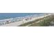Expansive beach with colorful umbrellas and ocean views, inviting relaxation and seaside enjoyment at 978 Cherrystone Loop, Conway, SC 29526