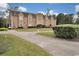 Stately building with stone tower, well-manicured grounds, circular driveway, and golf cart at 978 Cherrystone Loop, Conway, SC 29526