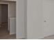 Hallway with neutral walls, carpet, and visible doorways showcasing the home's layout at 978 Cherrystone Loop, Conway, SC 29526