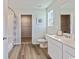 Well-lit bathroom with a double vanity, a toilet, modern fixtures, and a walk in shower at 985 Cherrystone Loop, Conway, SC 29526