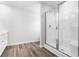 Bathroom featuring a walk-in shower with glass door, a vanity, and luxury vinyl plank flooring at 985 Cherrystone Loop, Conway, SC 29526