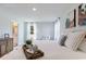 Serene bedroom with a large bed, plush pillows, and natural light from the windows at 985 Cherrystone Loop, Conway, SC 29526