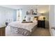 Bright main bedroom with a king size bed, a nightstand, neutral carpeting, and stylish decor at 985 Cherrystone Loop, Conway, SC 29526