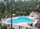 Community pool with lounge chairs and a pool house, surrounded by trees at 985 Cherrystone Loop, Conway, SC 29526