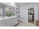 Bright bathroom with double vanity, framed mirror, and walk-in closet at 1016 Saluda River Rd., Myrtle Beach, SC 29588