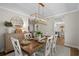 Stylish dining room with modern light fixture, round mirror, and seating for six at 1016 Saluda River Rd., Myrtle Beach, SC 29588