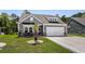 Charming single-Gathering home with a well-maintained lawn, inviting entrance, and a two-car garage at 1016 Saluda River Rd., Myrtle Beach, SC 29588