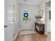 Inviting foyer with hardwood floors, console table, and decorative mirror, leading to the rest of the home at 1016 Saluda River Rd., Myrtle Beach, SC 29588