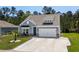 Charming single-story home with a two-car garage, well-manicured lawn, and inviting front porch at 1016 Saluda River Rd., Myrtle Beach, SC 29588