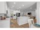 Bright, open kitchen with white cabinets, stainless steel appliances, and hardwood floors at 1016 Saluda River Rd., Myrtle Beach, SC 29588