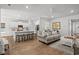 Open-concept living room with sofa, kitchen island with bar stools, and hardwood flooring at 1016 Saluda River Rd., Myrtle Beach, SC 29588