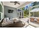 Relaxing screened porch with comfortable seating and a view of the outdoor patio and lush landscaping at 1016 Saluda River Rd., Myrtle Beach, SC 29588