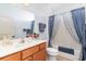 Well-lit bathroom with modern fixtures including a sink, vanity, toilet, and a bathtub with a decorative shower curtain at 126 Ella Kinley Circle # 401, Myrtle Beach, SC 29588