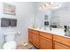 Well-lit bathroom with wood cabinets, white countertop, and a sleek mirror, blending functionality with style at 126 Ella Kinley Circle # 401, Myrtle Beach, SC 29588