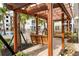 Charming courtyard featuring shaded seating, a pergola, and a view of a swimming pool, perfect for relaxation at 126 Ella Kinley Circle # 401, Myrtle Beach, SC 29588