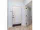 Bright entryway with light blue walls, a white front door, wood-look floors, and a peek into the next room at 126 Ella Kinley Circle # 401, Myrtle Beach, SC 29588