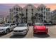 Condo building exterior with outside staircases, parking area, and beautiful palm trees surrounding at 126 Ella Kinley Circle # 401, Myrtle Beach, SC 29588