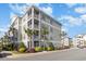 Attractive condo building with multi-level balconies, lush landscaping, and well-maintained surroundings at 126 Ella Kinley Circle # 401, Myrtle Beach, SC 29588
