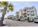 External view of a multilevel condo building featuring well-maintained parking, landscaping, and exterior stairwells at 126 Ella Kinley Circle # 401, Myrtle Beach, SC 29588