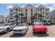 External shot of a multilevel condo building with parking area, palm trees, and outdoor staircases at 126 Ella Kinley Circle # 401, Myrtle Beach, SC 29588
