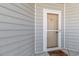 Close-up of a unit entrance featuring neutral siding, a white-framed door, and a welcoming doormat at 126 Ella Kinley Circle # 401, Myrtle Beach, SC 29588
