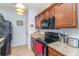 Well-equipped kitchen featuring granite countertops, a modern cooktop, and wooden cabinets providing ample storage space at 126 Ella Kinley Circle # 401, Myrtle Beach, SC 29588