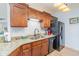 Kitchen featuring granite countertops, stainless steel appliances, and warm wood cabinetry, creating an inviting space at 126 Ella Kinley Circle # 401, Myrtle Beach, SC 29588