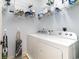 Efficient laundry room featuring a white washer and dryer set, storage shelves, and organized cleaning supplies at 126 Ella Kinley Circle # 401, Myrtle Beach, SC 29588