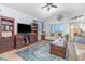 Bright living room features vaulted ceilings, neutral furniture, wood flooring, and a sliding glass door to a balcony at 126 Ella Kinley Circle # 401, Myrtle Beach, SC 29588