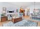 Spacious living area with stylish furnishings, wood floors, and a seamless transition to the dining and kitchen areas at 126 Ella Kinley Circle # 401, Myrtle Beach, SC 29588