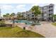 Exterior angle of a pool area featuring a large pool with lounge chairs and a gray condo building at 126 Ella Kinley Circle # 401, Myrtle Beach, SC 29588
