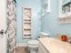 Bathroom showing blue walls, seashell shower curtain, vanity and built-in storage at 1310 N Waccamaw Dr. # 211, Garden City Beach, SC 29576